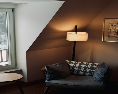 Cozy reading nook with warm ambient lamp light by the window